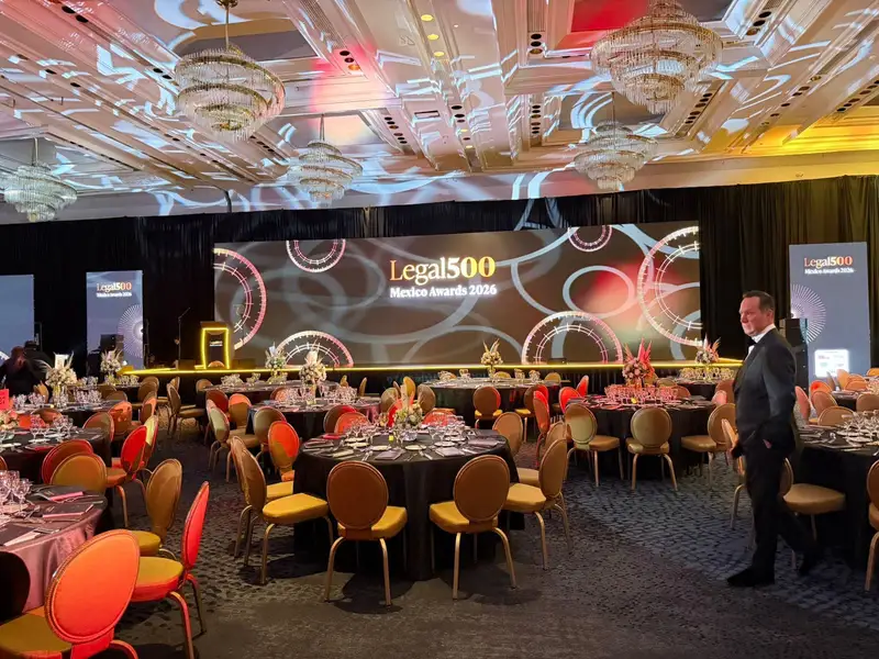 Techo de un salón de gala iluminado con proyecciones de gobos y escenario con pantalla LED